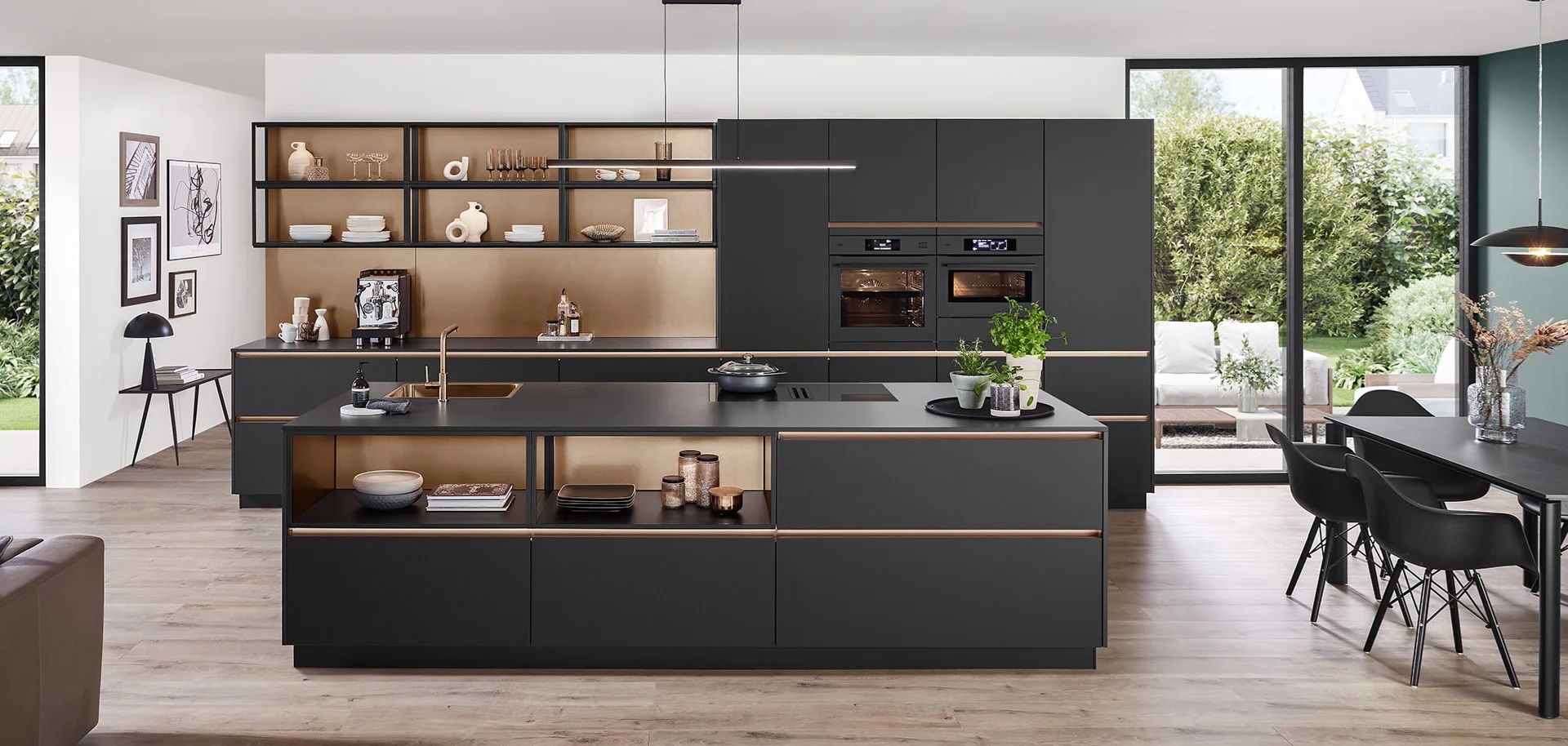 Dark slab-front German kitchen with an island and recessed bronze opening rails